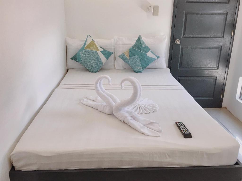 Postel nebo postele na pokoji v ubytování Palmera El Nido Inn