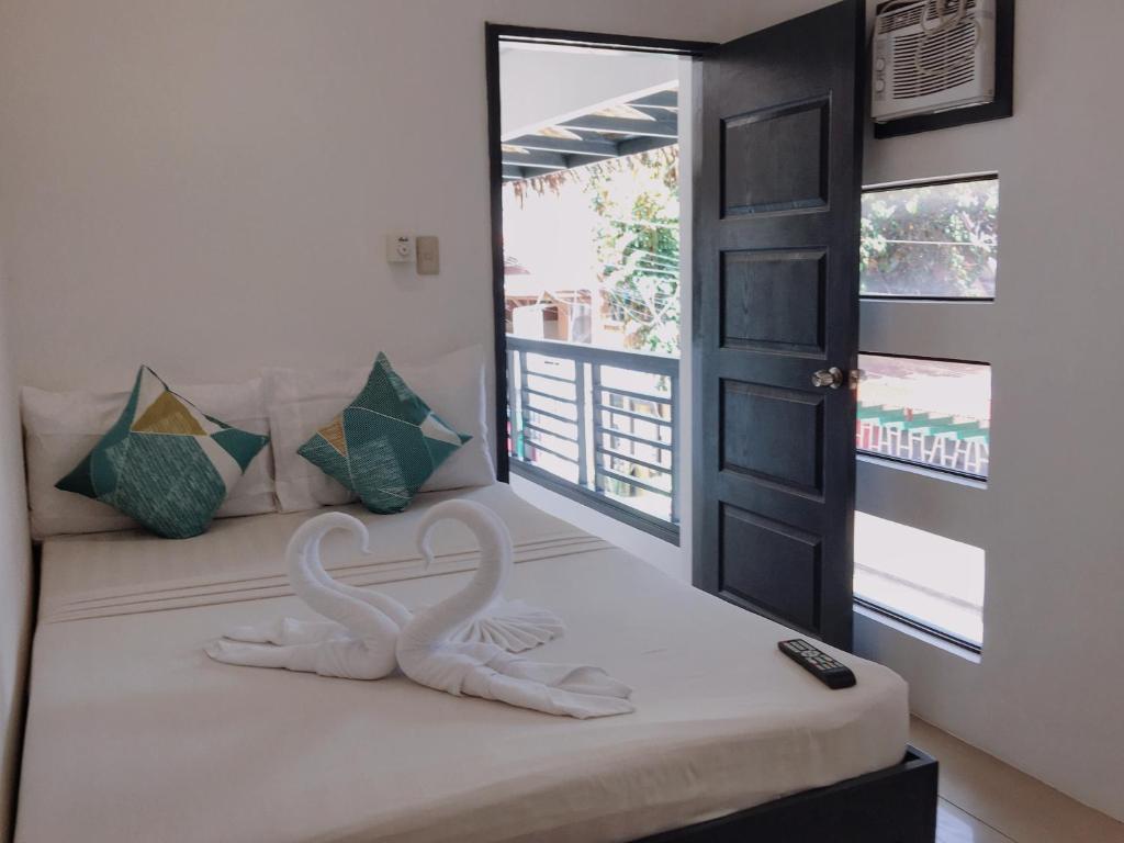 Postel nebo postele na pokoji v ubytování Palmera El Nido Inn