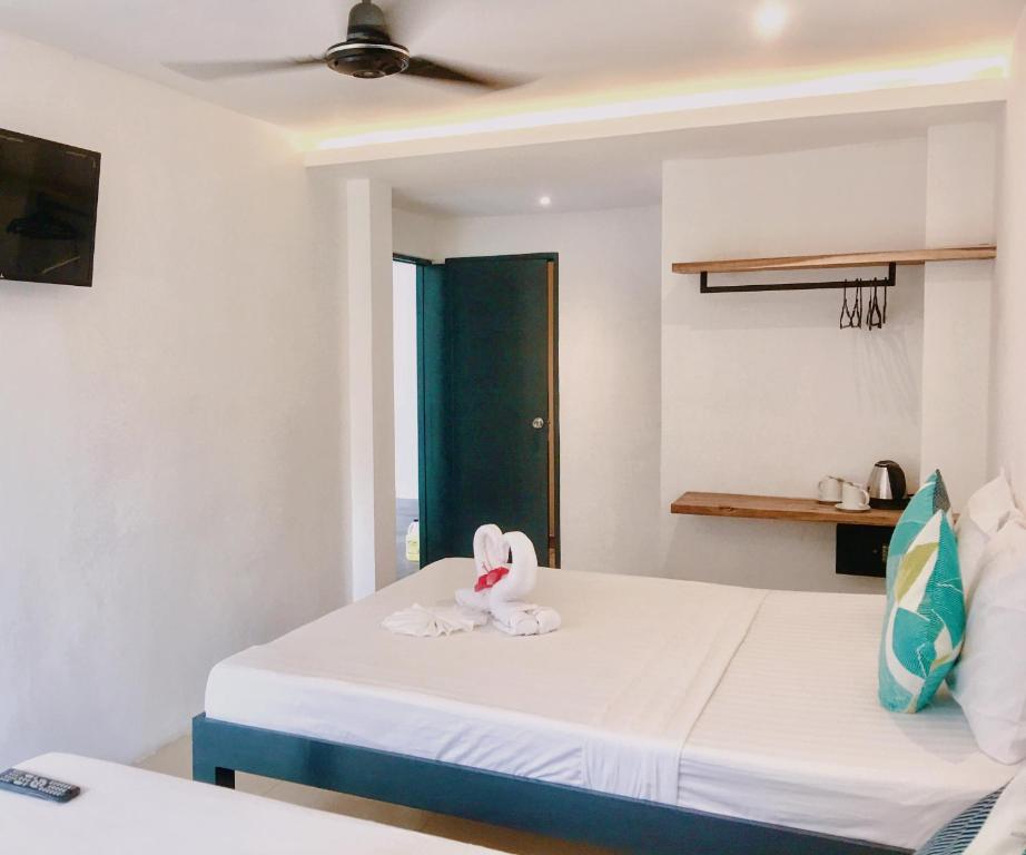 Postel nebo postele na pokoji v ubytování Palmera El Nido Inn