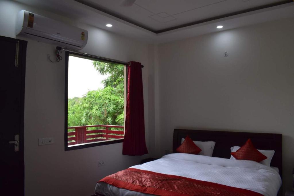 a bedroom with a bed and a window at The Starling BnB in Greater Noida