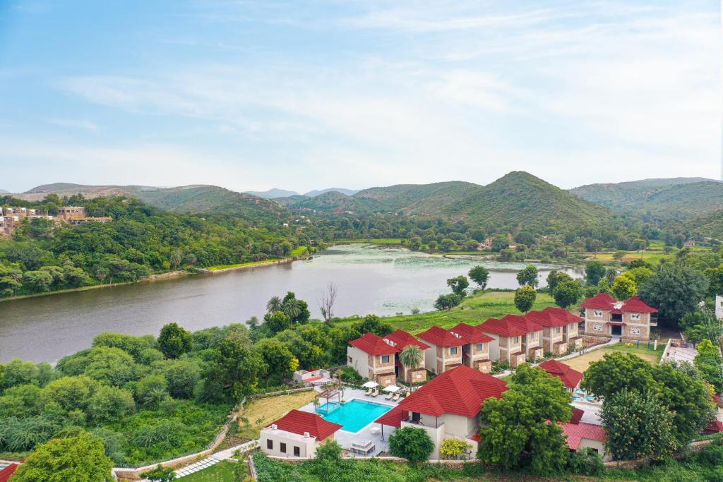 an aerial view of a resort with a river and mountains at Sarasiruham Resort - Private Pool Villa in Udaipur in Udaipur