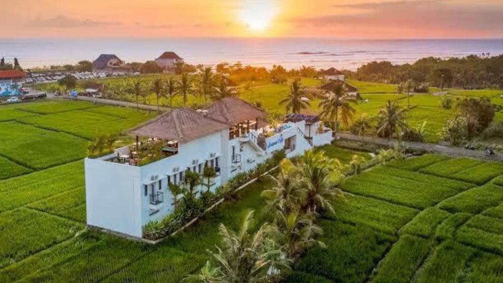 an aerial view of a house in a field at Swell Hotel, Pool Bar & Restaurant in Tanah Lot
