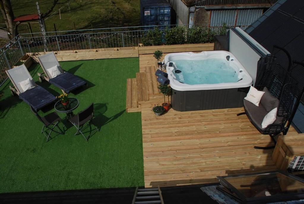 an overhead view of a backyard with a hot tub and chairs at Stunning Luxury Duplex with Hot Tub and AirCon in Glenfarg