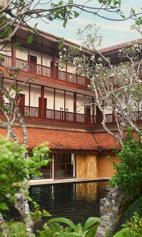 an external view of a building with a balcony at Cinnamon Bentota Beach - Signature Selection in Bentota