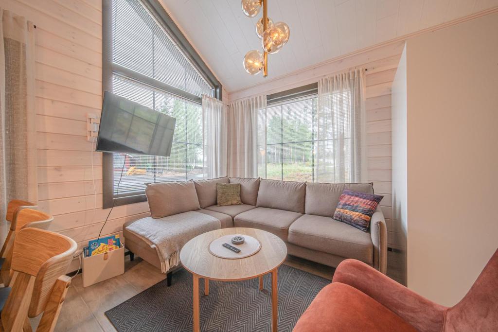 a living room with a couch and a table at Levillas Sointuilevi 1A72, 2 ski pass included in Levi