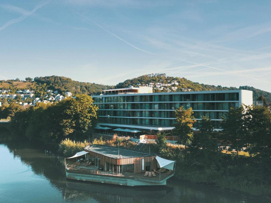 a boat in the water in front of a building at Emser ThermenHotel in Bad Ems