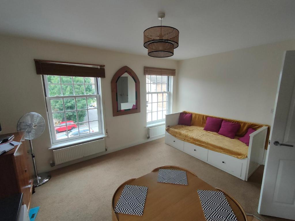 a living room with a couch and a table at Central Taunton 2-bedroom apartment, great location! in Taunton