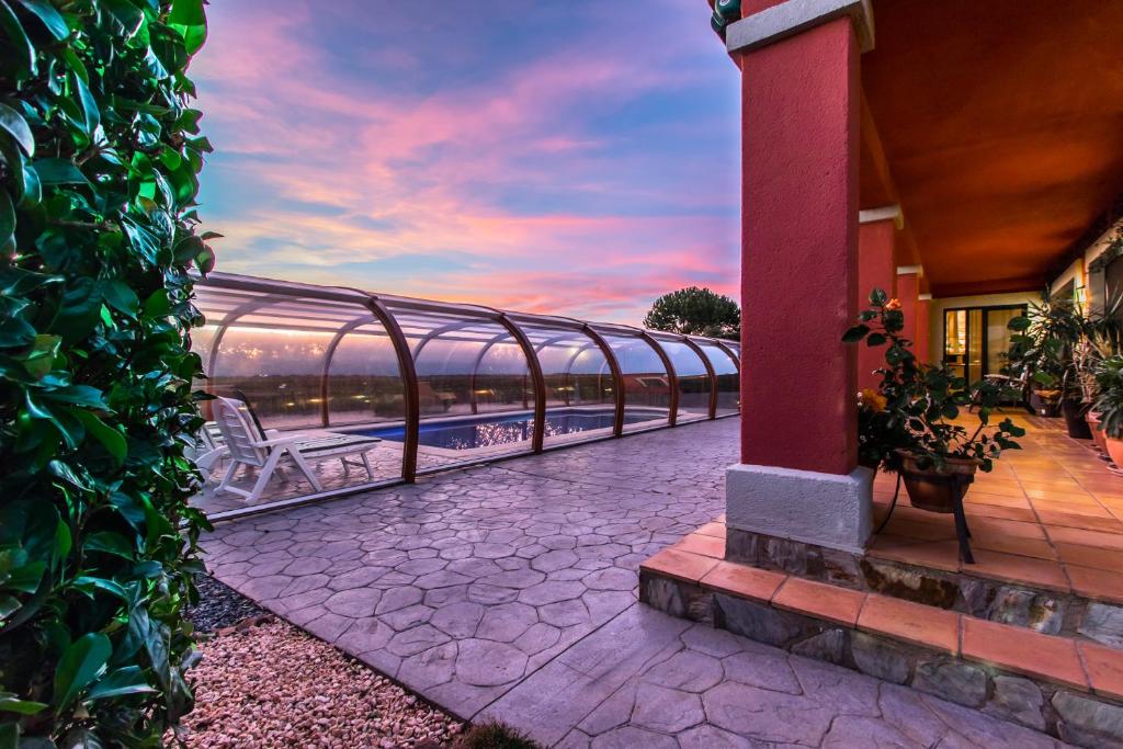 a balcony with a view of the ocean at sunset at Casa La Perla in Golf of Peralada in Peralada