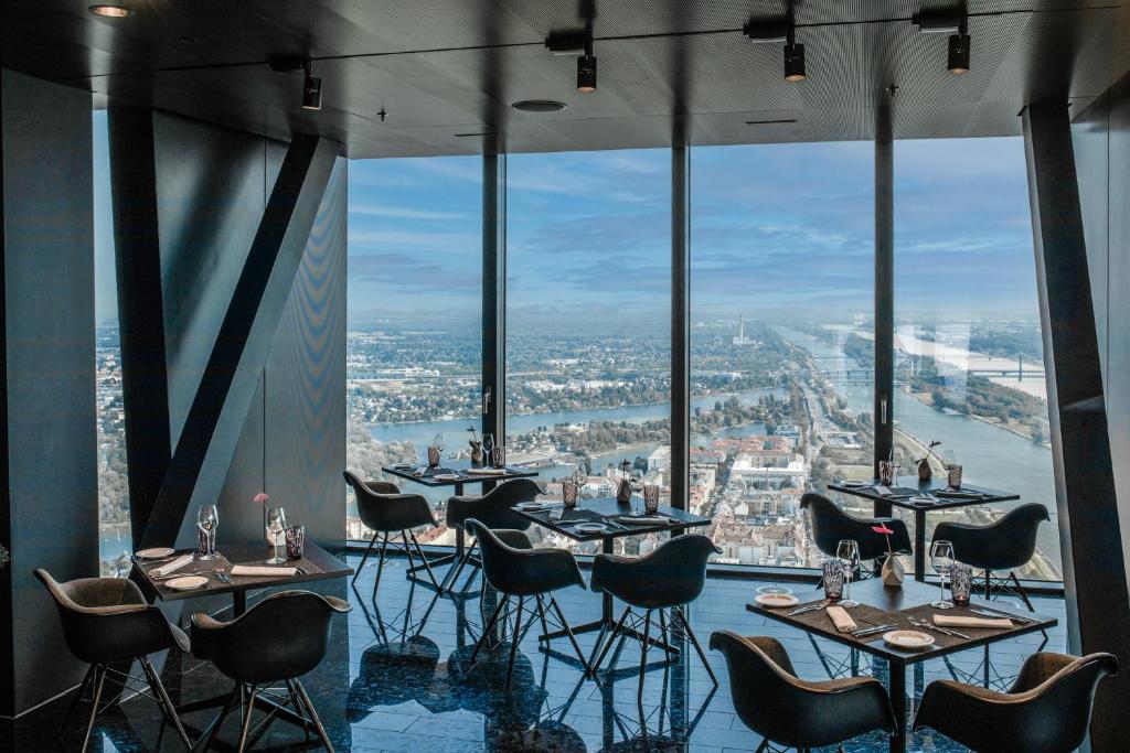 a restaurant with tables and chairs in front of a window at Melia Vienna in Vienna