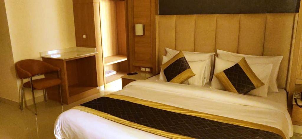 a bedroom with a large bed in a room at Hotel Sakura by Maps in Gurgaon