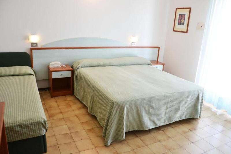Postel nebo postele na pokoji v ubytování Hotel Cinzia