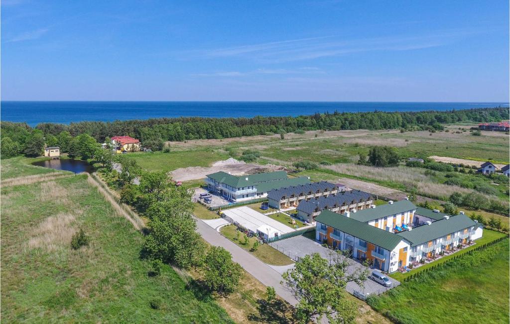 an aerial view of a building with the ocean in the background at Cozy Home In Grzybowo With Kitchen in Grzybowo