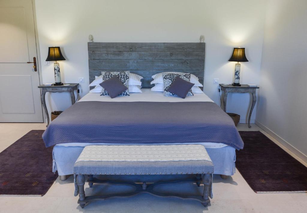 a bedroom with a large bed and two night stands at La Bastide Neuve in Joucas