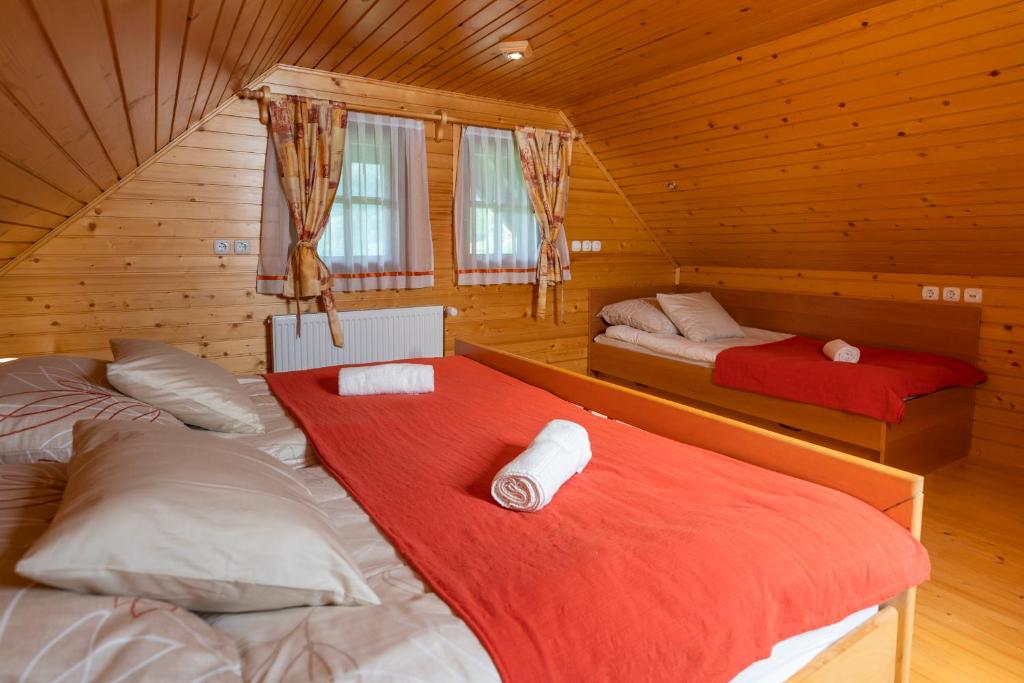 a room with two beds in a log cabin at Chalet Ajda in Bohinj