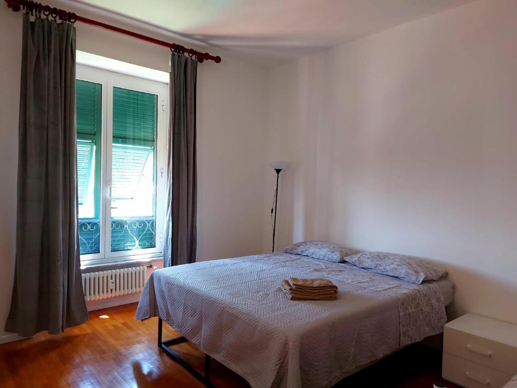 a bedroom with a bed in front of a window at La dulce stanza in Genova