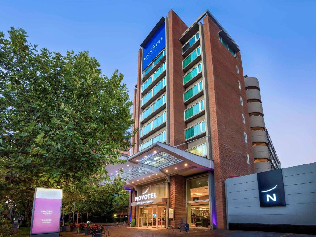 a building with a sign on the side of it at Novotel Santiago Vitacura in Santiago