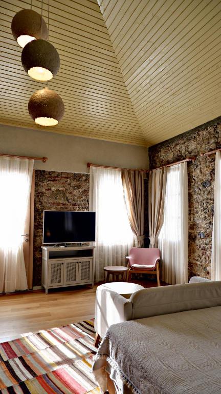 a living room with a bed and a flat screen tv at Bono Hotel Old Town in Marmaris