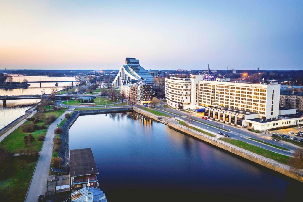 a view of a city with a river and buildings at Radisson Blu Daugava Hotel, Riga in Riga
