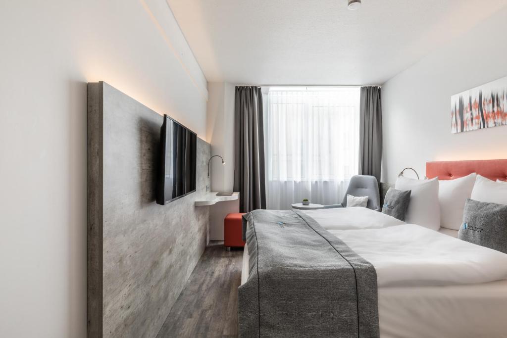Postel nebo postele na pokoji v ubytování Garner Hotel Wiesbaden City