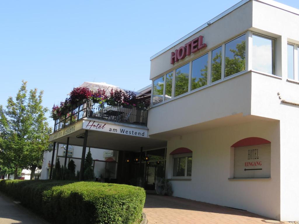 a white building with a bulgur sign on it at Hotel am Westend in Lahr
