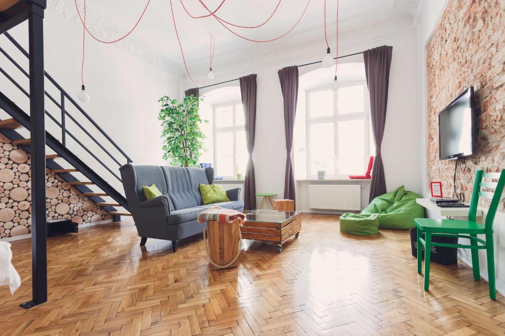 a living room with a couch and a table at City Vibes Apartments in Krakow