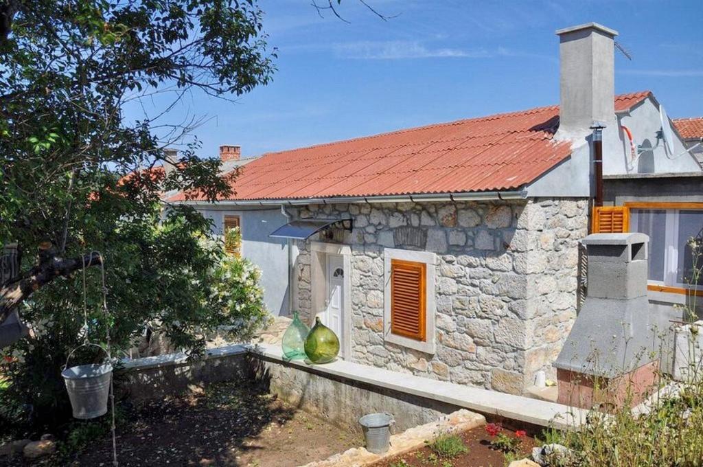 an old stone house with a red roof at Apartments by the sea Veli Rat, Dugi otok - 15006 in Veli Rat