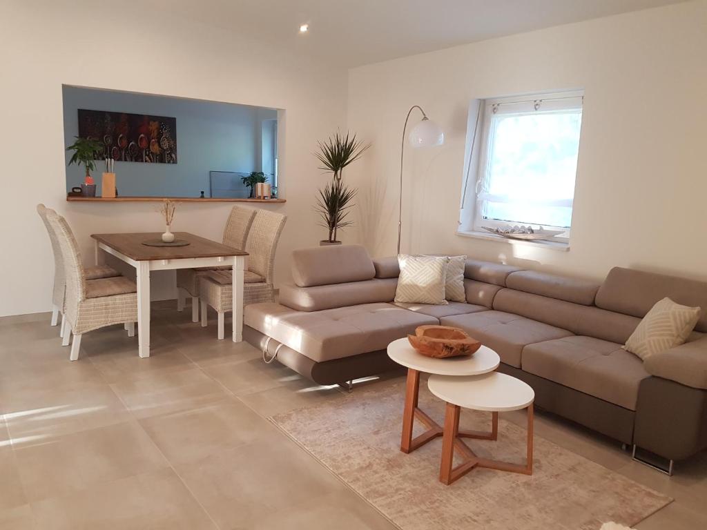 a living room with a couch and a table at Oase am Nationalpark in Kargow