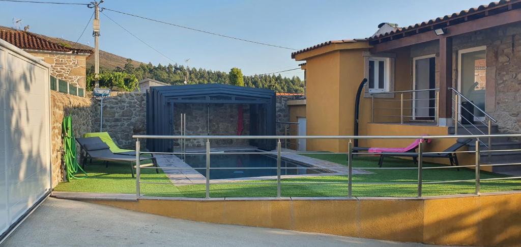 a balcony with two chairs and a swimming pool at Casa Pinto - AL in Valença