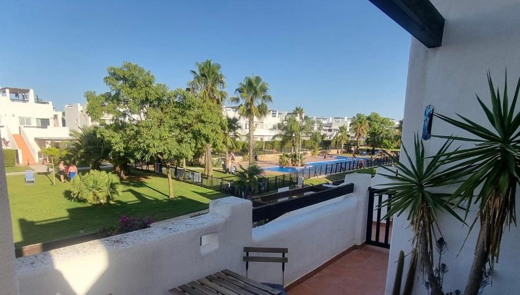 a balcony with a view of a swimming pool at Condado De Alhama Golf Resort 2 Bedroom Apartment Jardine 13 in Murcia