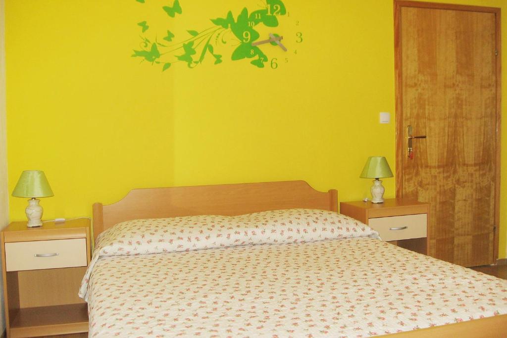 a bedroom with a bed and two night stands with lamps at Apartments and rooms with parking space Bol, Brac - 2878 in Bol