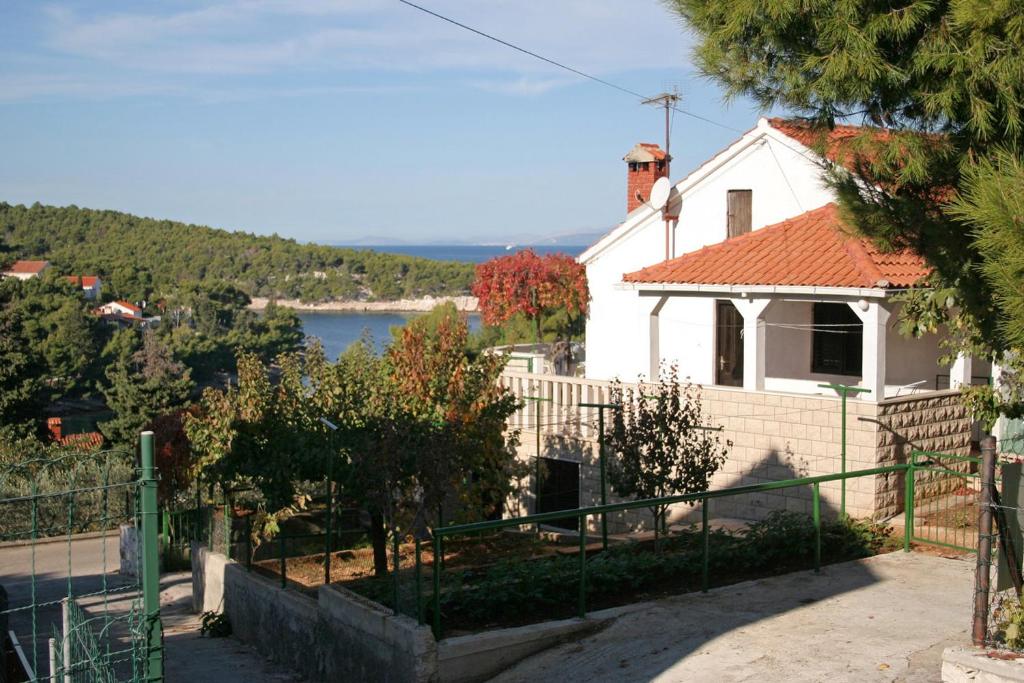 a white house with a view of the water at Apartments by the sea Splitska, Brac - 2923 in Postira
