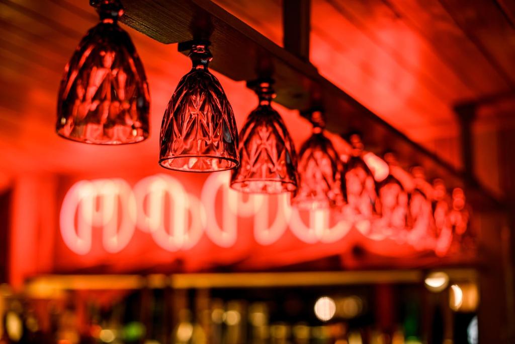 two lights hanging from a red wall in a bar at Ozon Gudauri in Gudauri