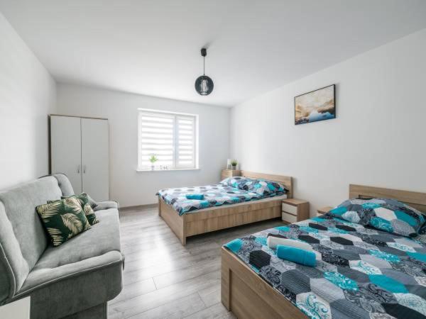 Ένα ή περισσότερα κρεβάτια σε δωμάτιο στο Apartamenty NOVA