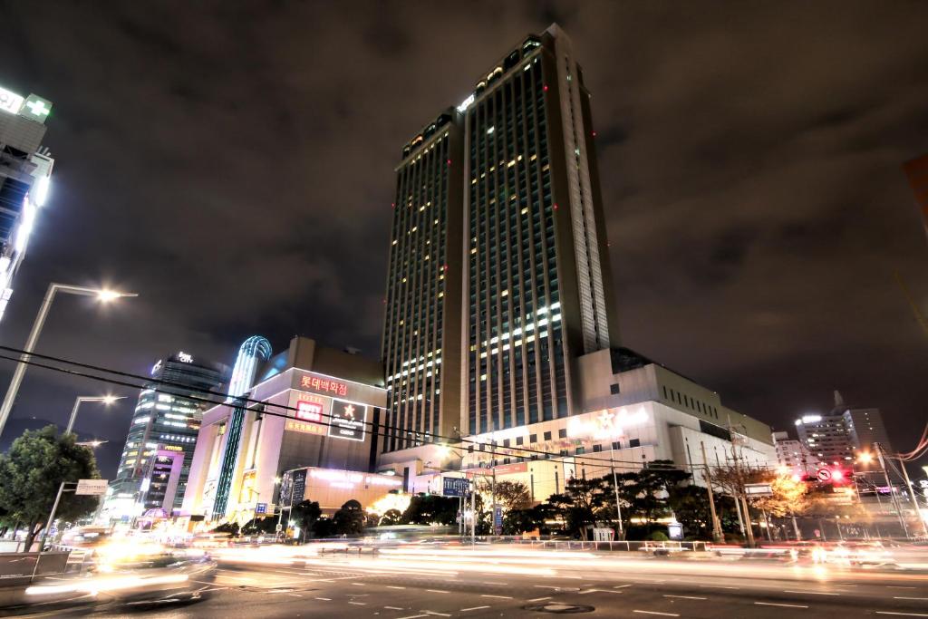 
a city street at night with tall buildings at Lotte Hotel Busan in Busan
