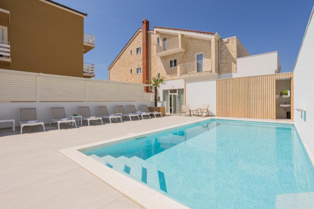 a swimming pool on the side of a building at Villa Miki in Podstrana