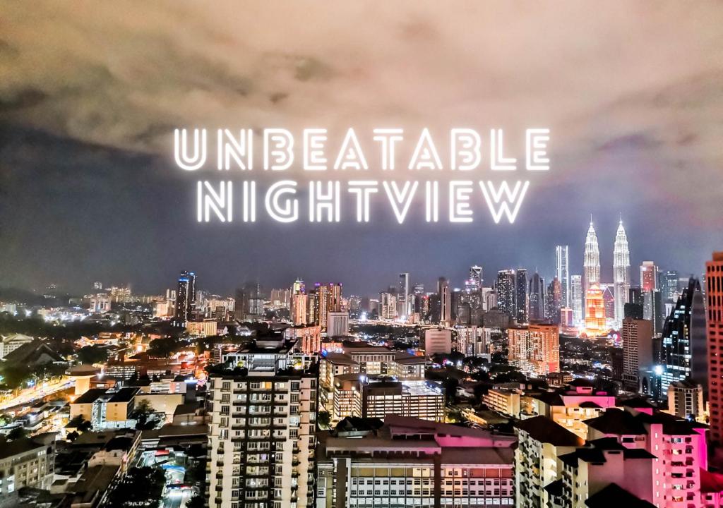 a city skyline with the words unreliable night view at TR Residence WTC Titiwangsa Monorail MRT Station KLCC HKL IJM Bukit Bintang in Kuala Lumpur