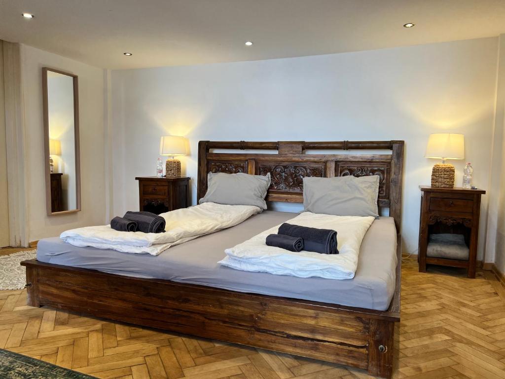 a large bed with two pillows on top of it at Cedar Inn Budapest - Palace District in Budapest