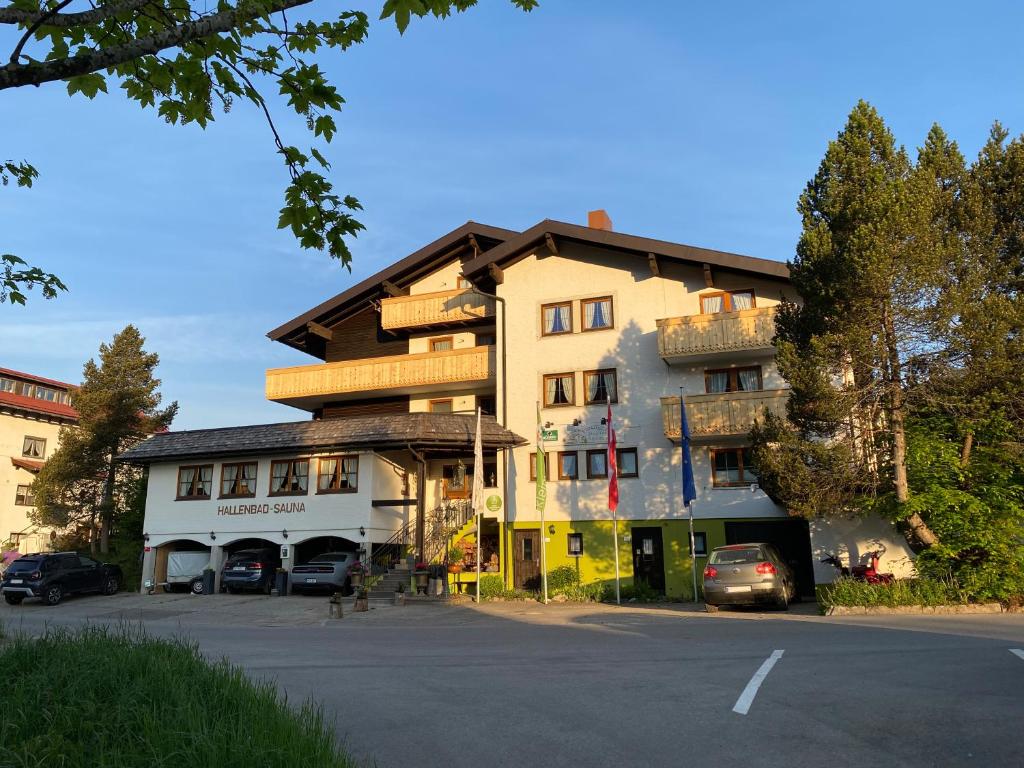 a large building on the side of a street at Hotel Alpensonne in Riezlern