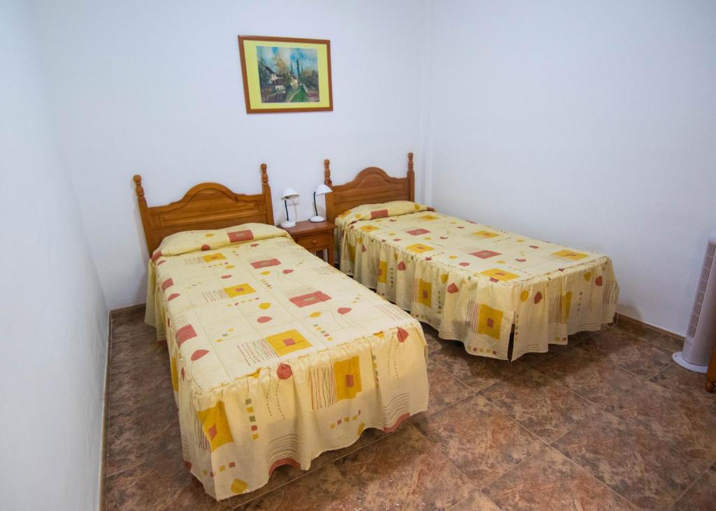 two twin beds in a room with at Apartamentos Alcalá - Tenerife in Alcalá