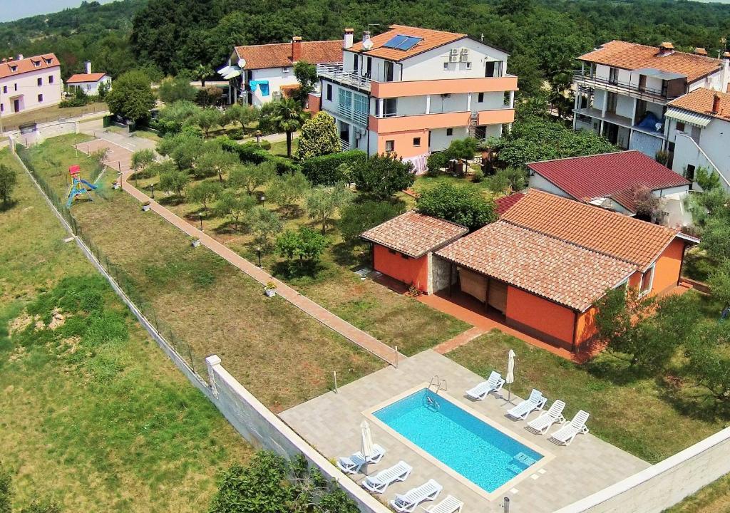 an aerial view of a house with a swimming pool at Apartments and rooms with a swimming pool Babici, Umag - 3046 in Umag