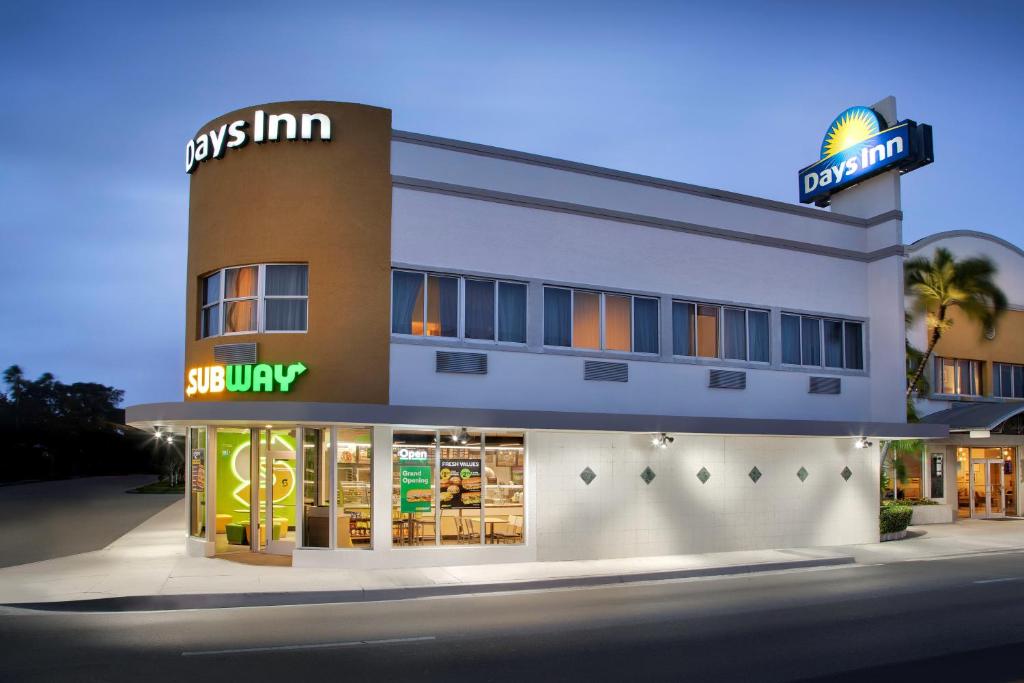 a store front of a building with a sign on it at Days Inn by Wyndham Miami Airport North in Miami