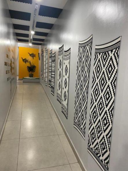 a hallway with art on the walls of a building at HOSTEL CUARTO in Sao Paulo