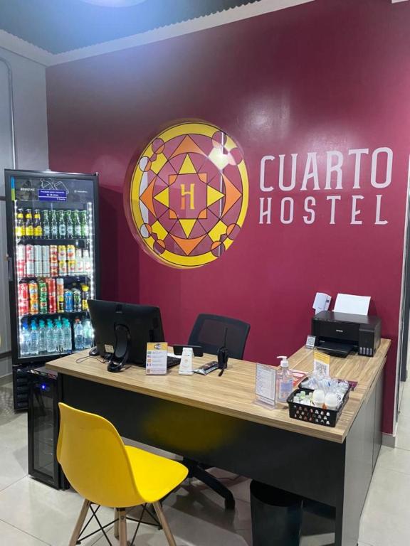 a counter in a store with a sign on a wall at HOSTEL CUARTO in Sao Paulo