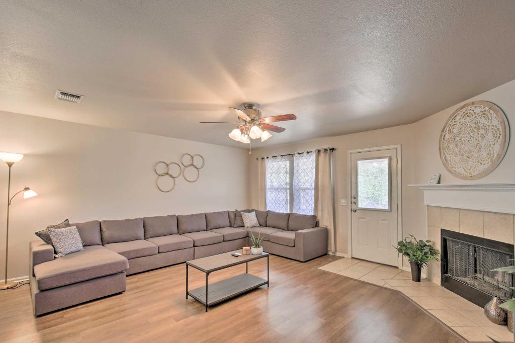 a living room with a couch and a fireplace at Family Getaway with Pool Access, Near SeaWorld! in San Antonio