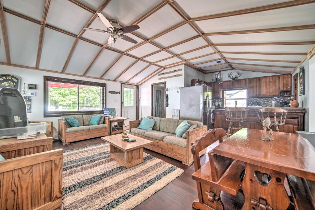 a living room with a couch and a table at Jamestown Retreat with Hot Tub - Walk to Lake! in Hartstown