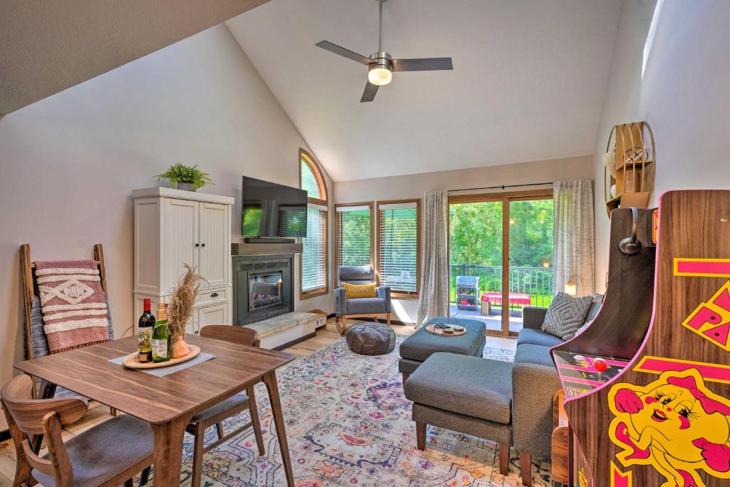 a living room with a table and chairs and a fireplace at Family-Friendly Galena Townhome with Community Pools in Galena