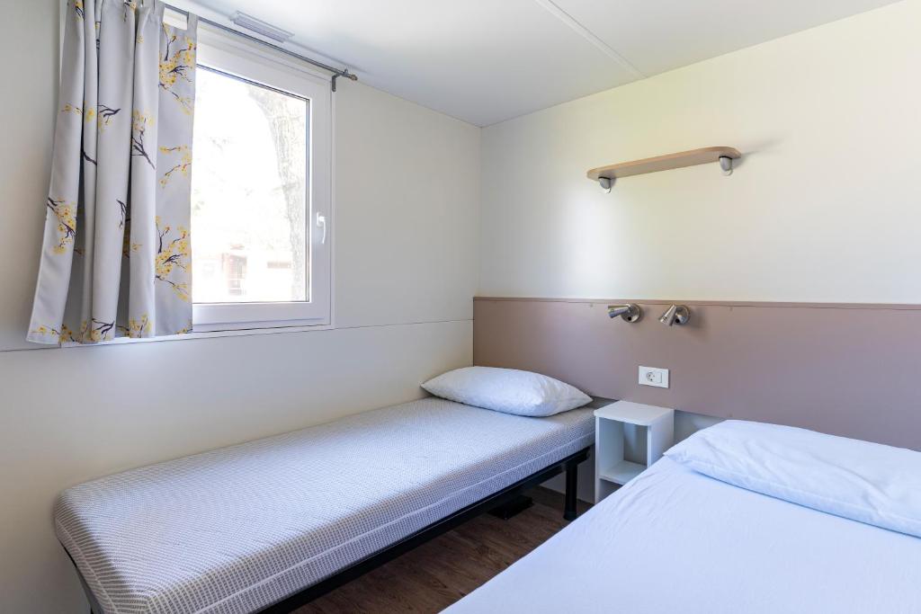 Postel nebo postele na pokoji v ubytování Camping Daino