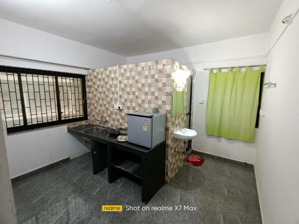 Телевизор и/или развлекательный центр в Palolem Sunrise Apartment