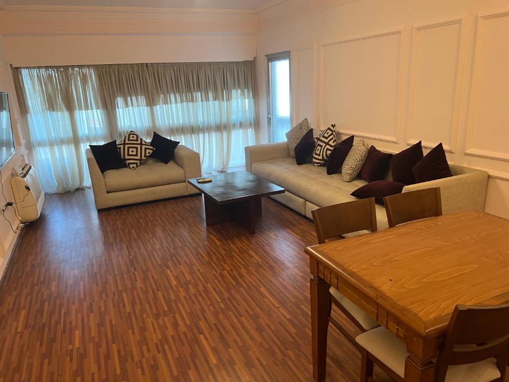 a living room with a couch and a table at Superbe appartement au centre de la capitale in Rabat