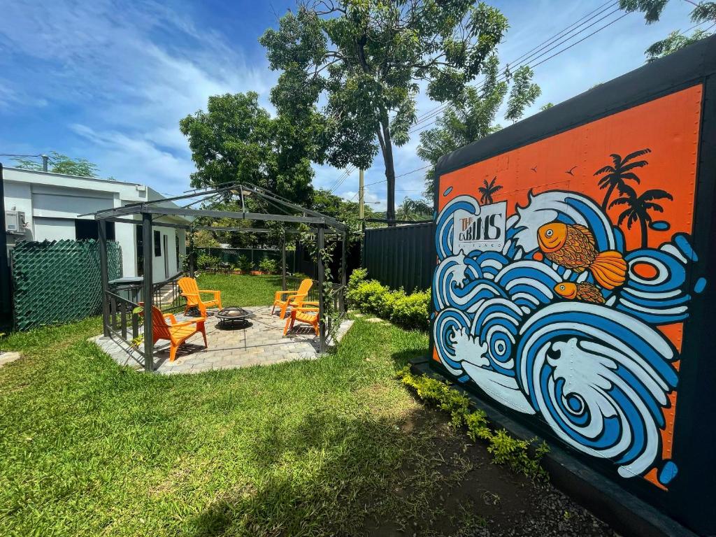 a wall with a painting of a wave on it at The Cabins in La Libertad